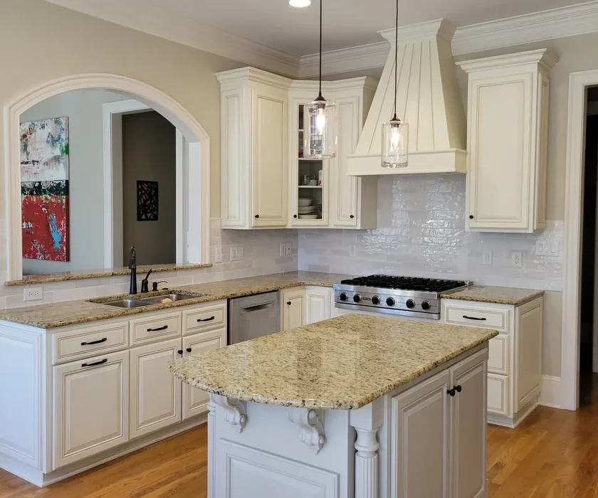 Stone countertop edge and tile backsplash detail in a remodeled kitchen