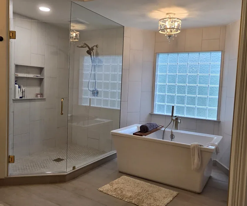 Remodeled bathroom with tiled walk-in shower and glass enclosure in a Charlotte, NC home