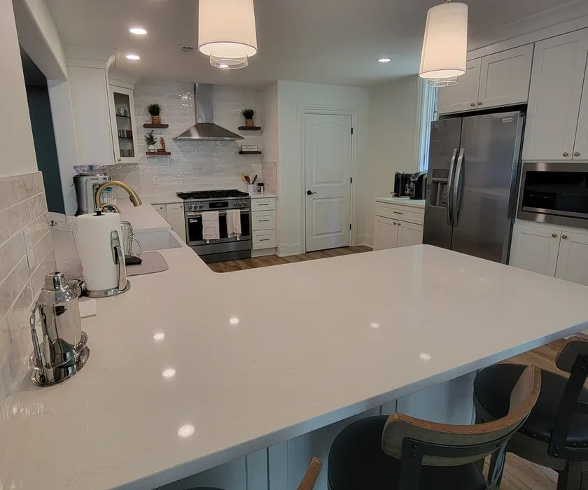 Remodeled kitchen with shaker cabinets, stone countertops and tile backsplash in Charlotte, NC