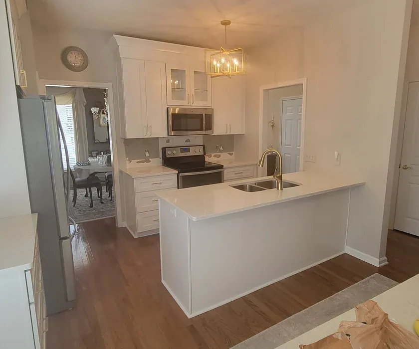 Stone countertop edge and tile backsplash detail in a remodeled kitchen